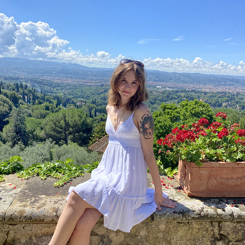 Hope Pulfrey sitting with the city of Florence in the background